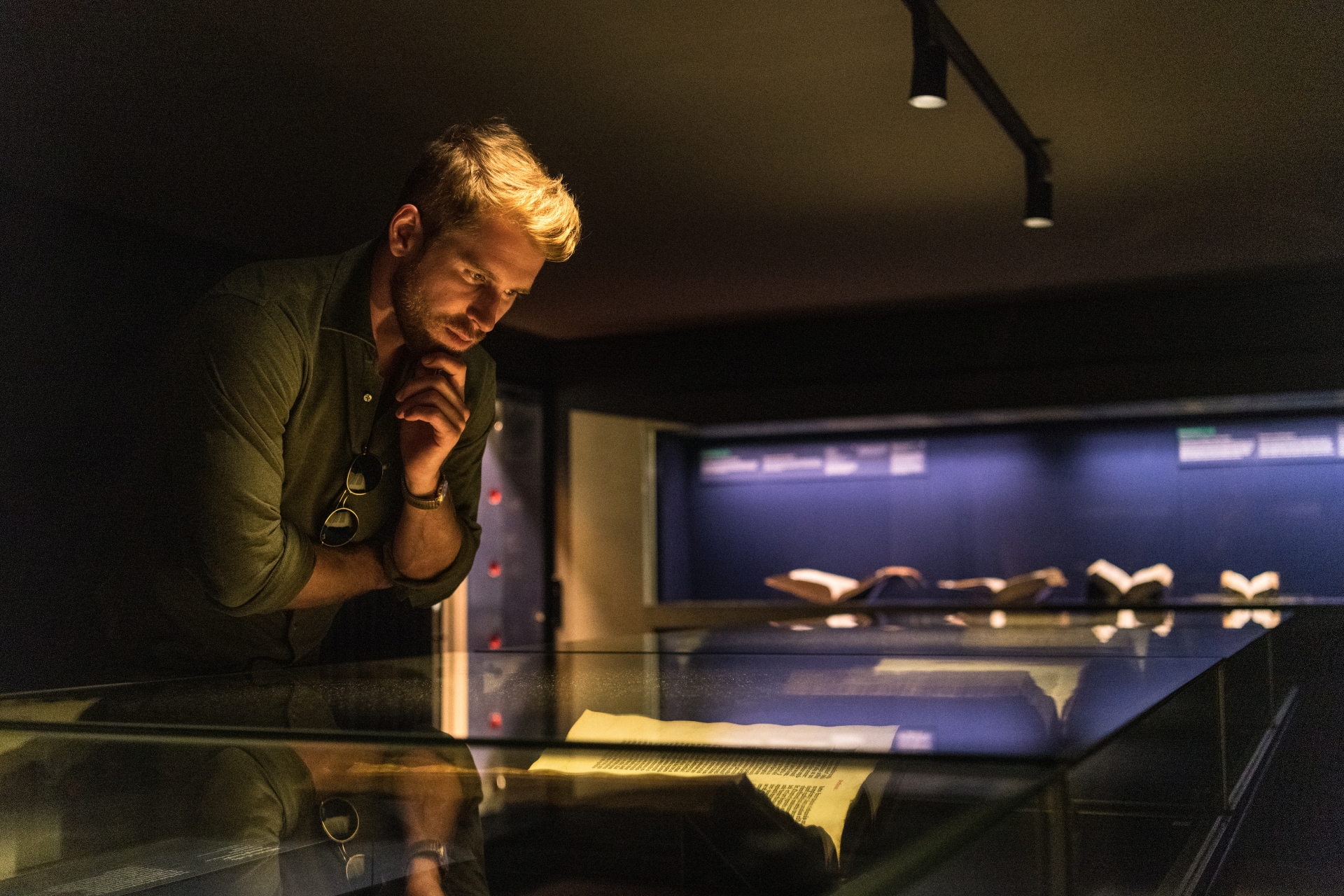 Un jeune homme regarde une exposition au Musée Gutenberg.